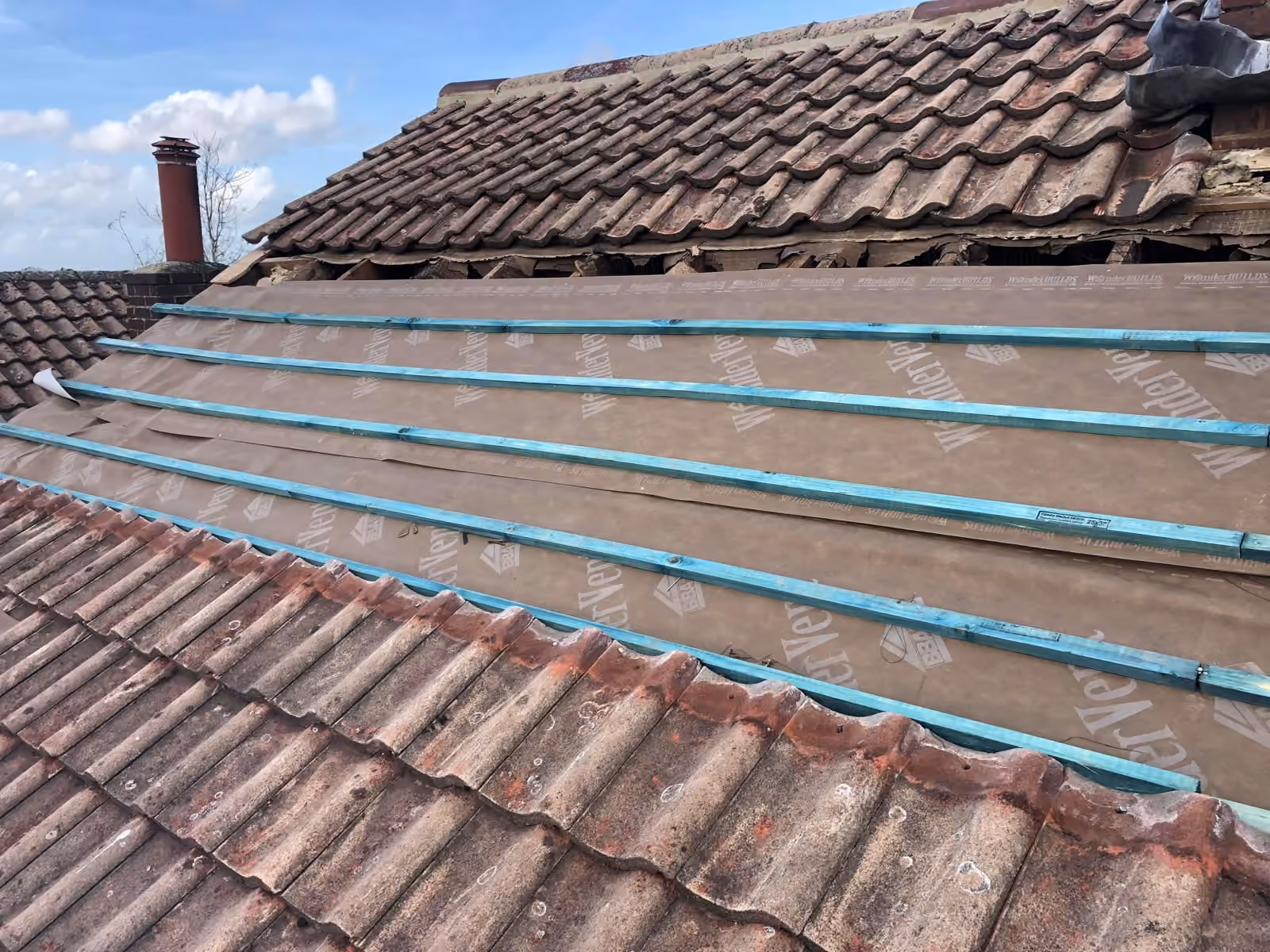 New treated battens laid over breathable underlay on a stripped pitch
