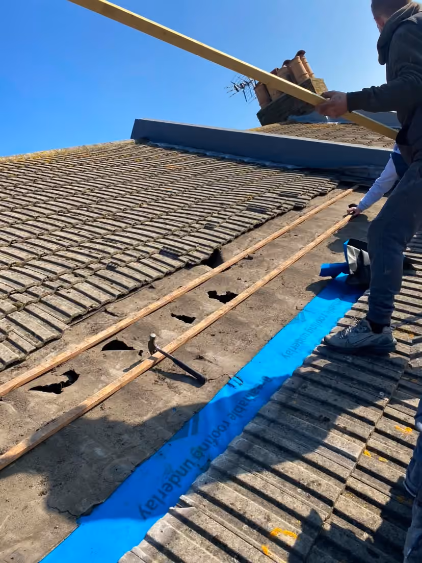Old tiles lifted off a pitch with underlay dressed underneath