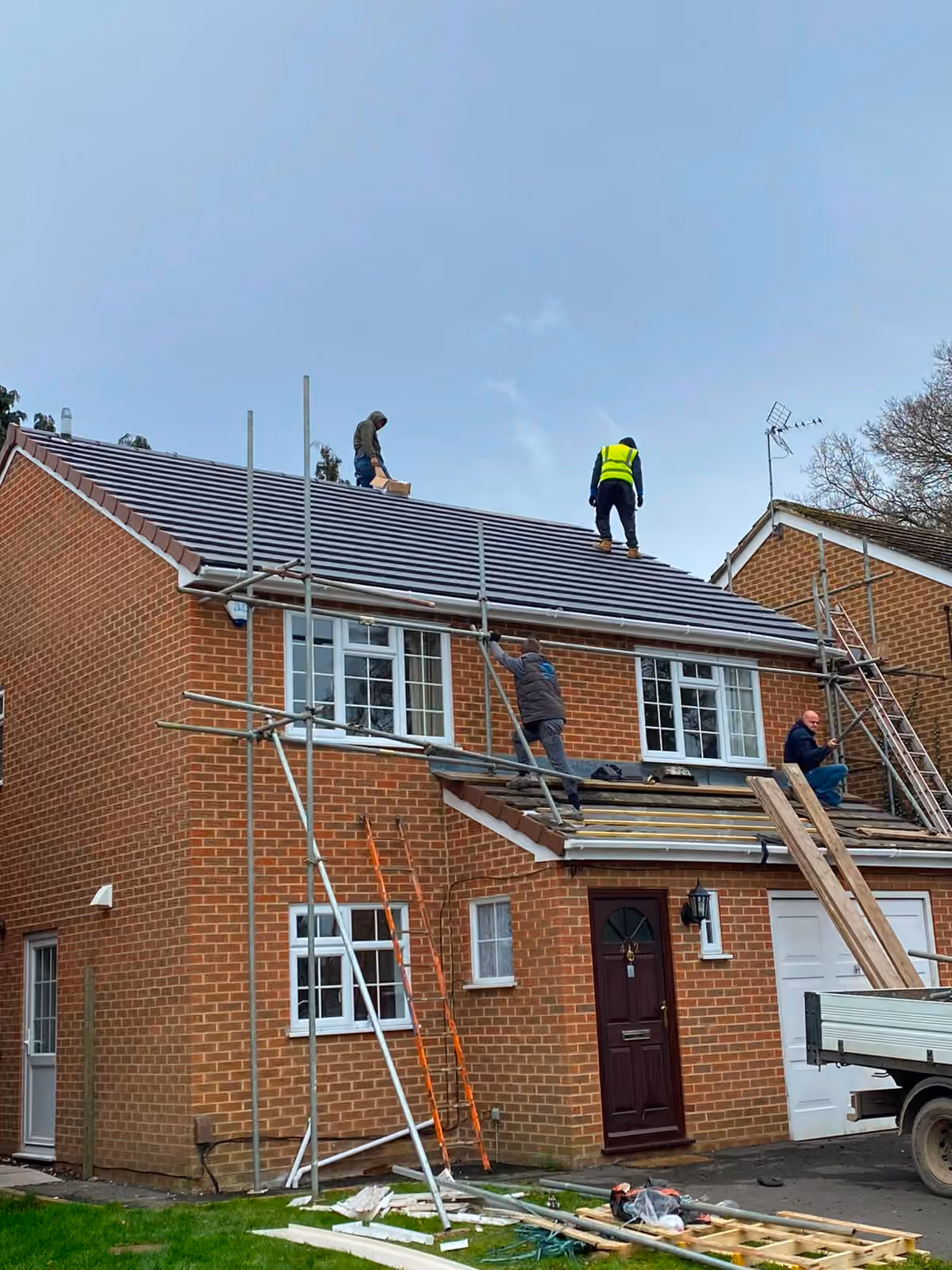 Scaffold up around a detached house with the roof being worked on