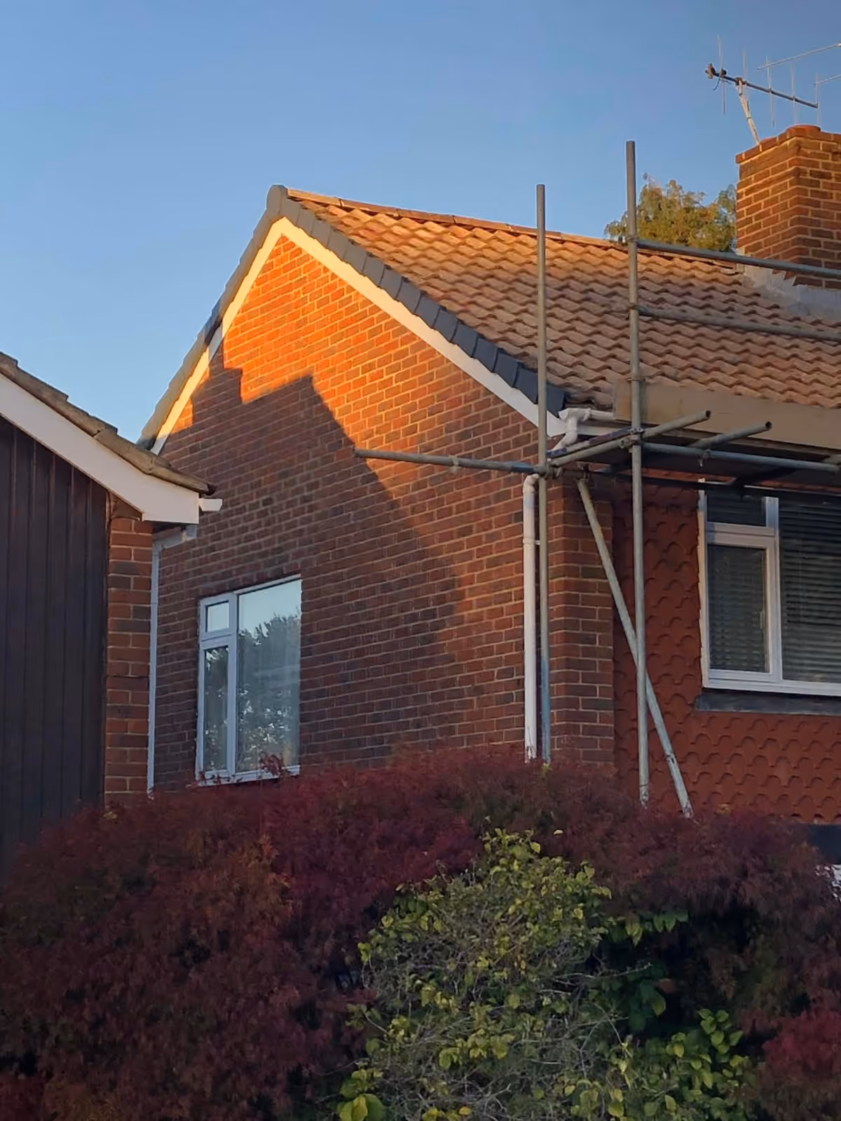 Scaffold standing against a house with the roof opened up