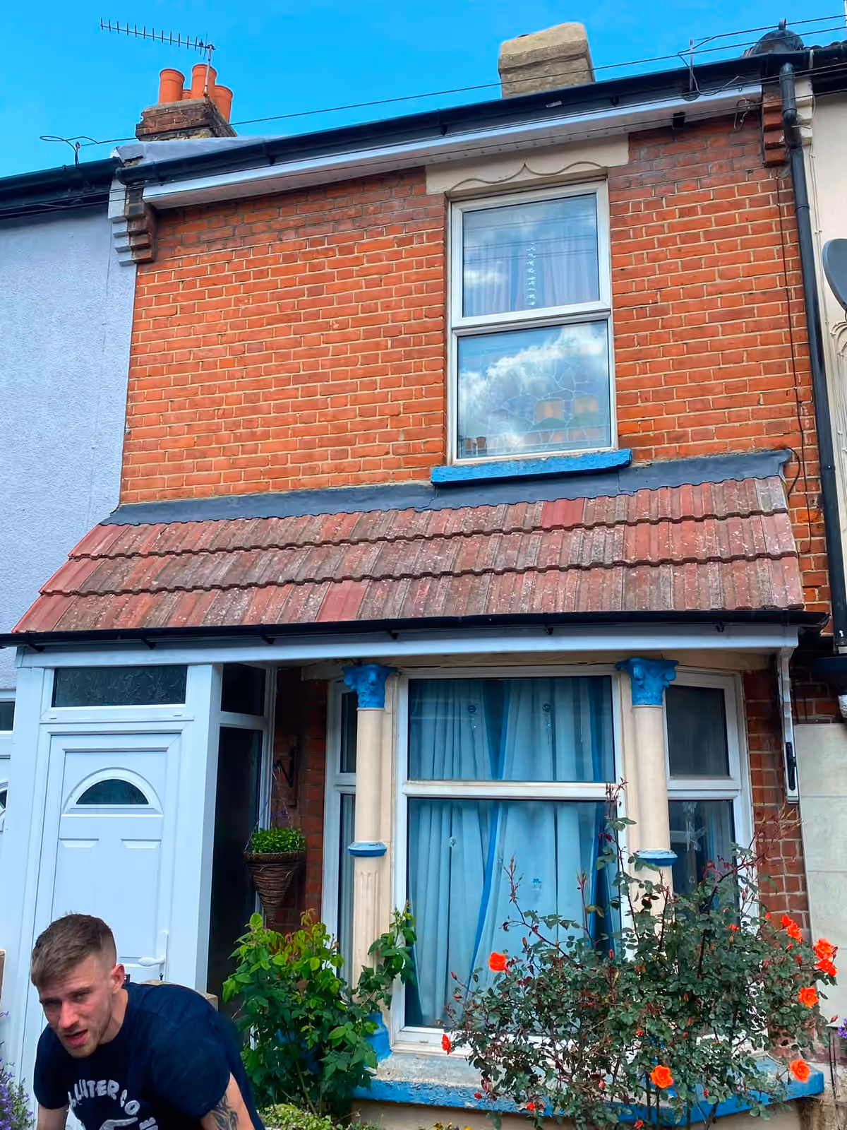 A terraced house front with the roof covering taken back