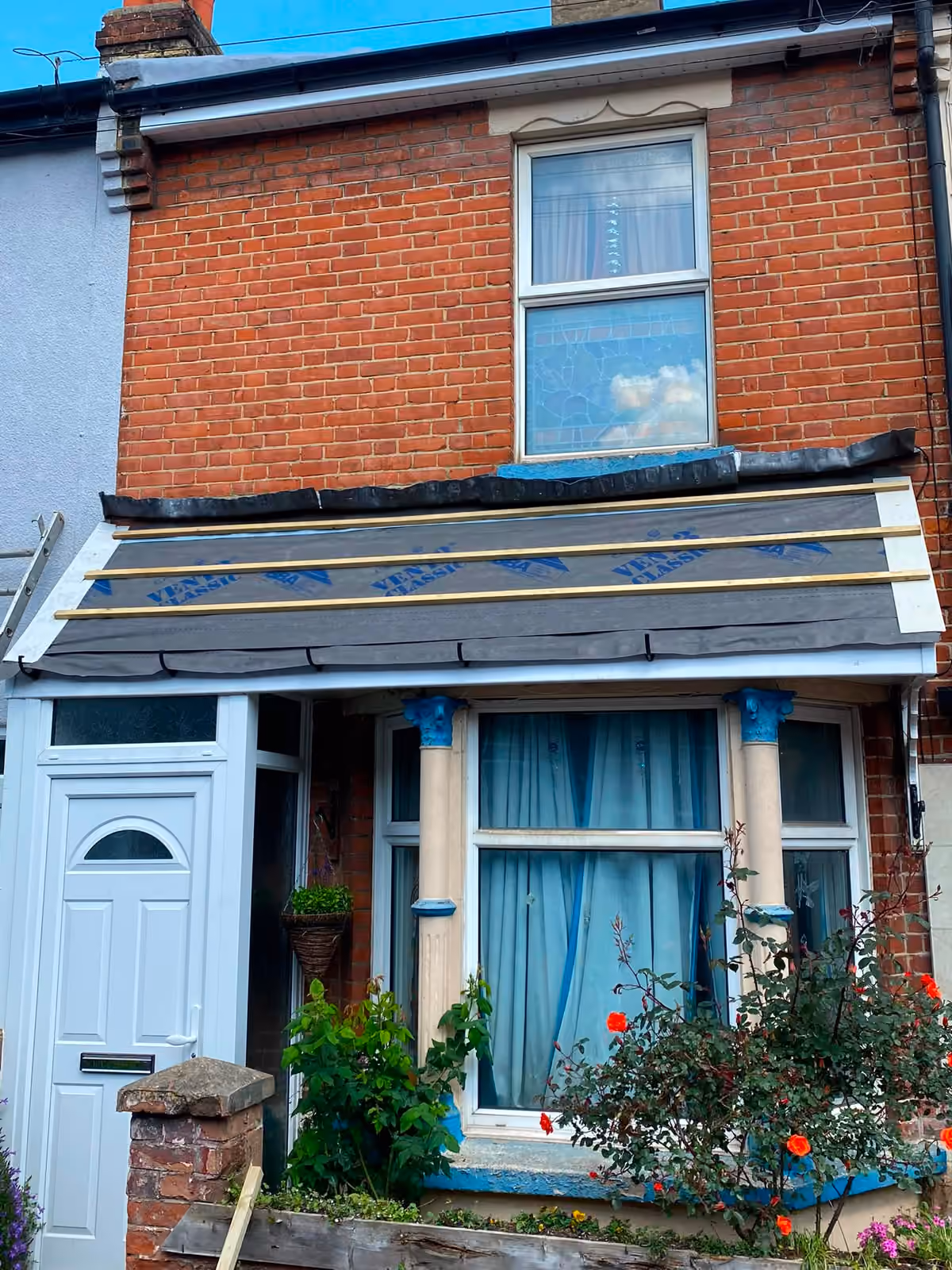 Front elevation of a terrace with the roofline stripped and underlay laid