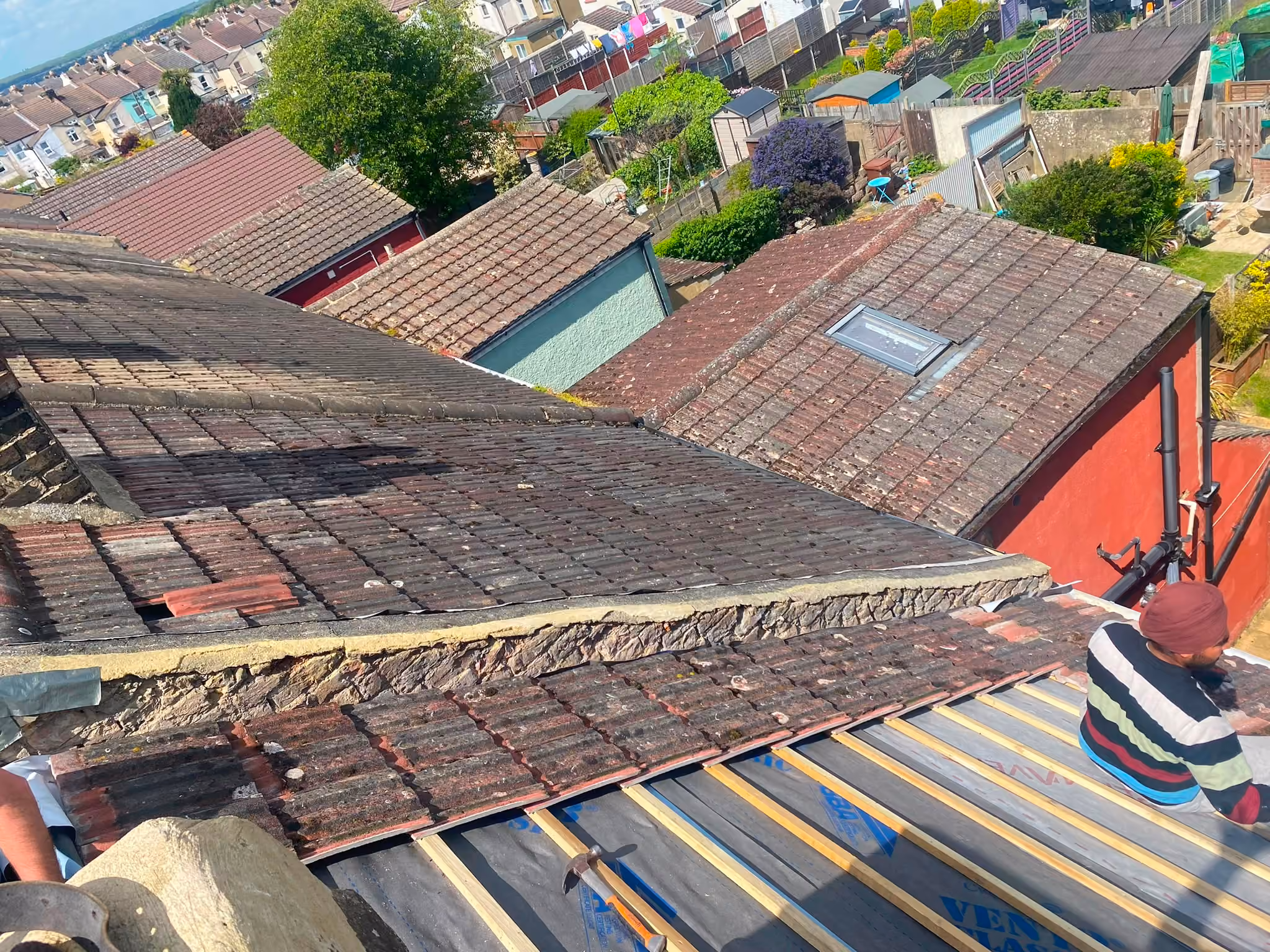 The verge of a tiled roof seen from the scaffold