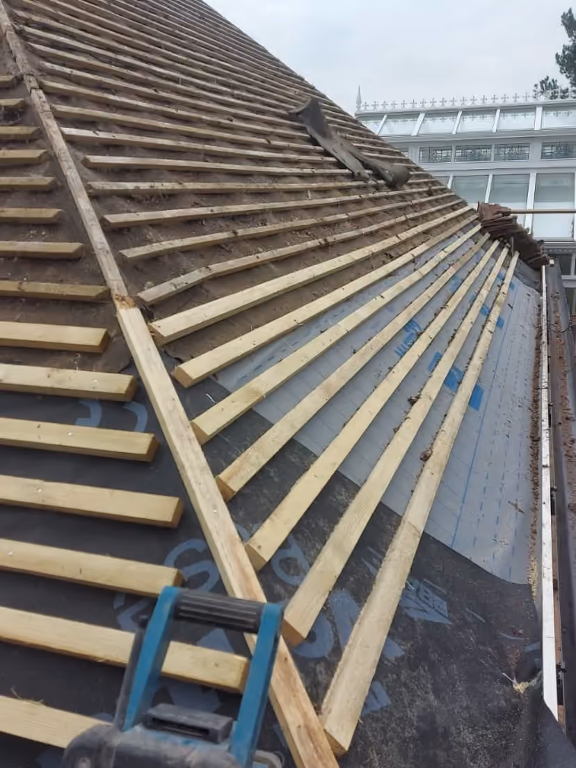 New battens laid along a pitch with a nail gun on them