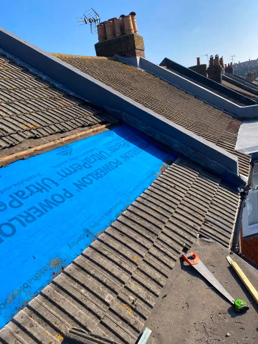 Blue breathable underlay dressed across a pitched roof