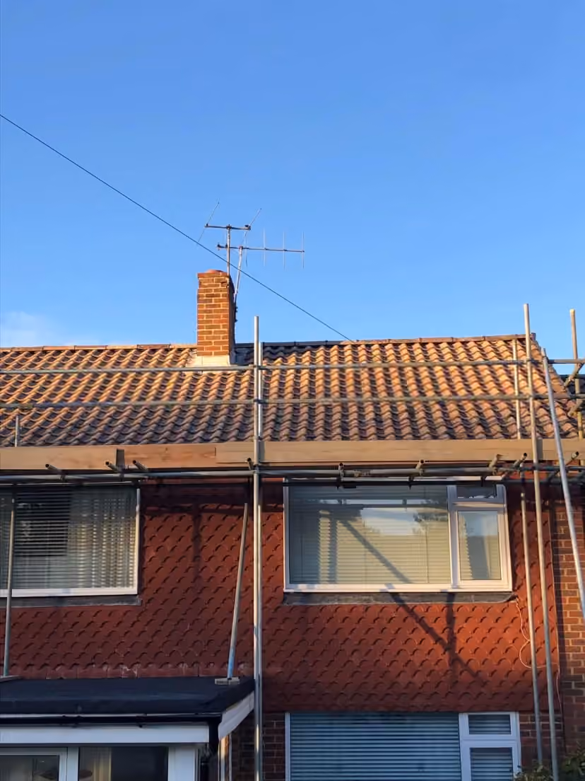 A semi with the roof half re-covered, scaffold in place