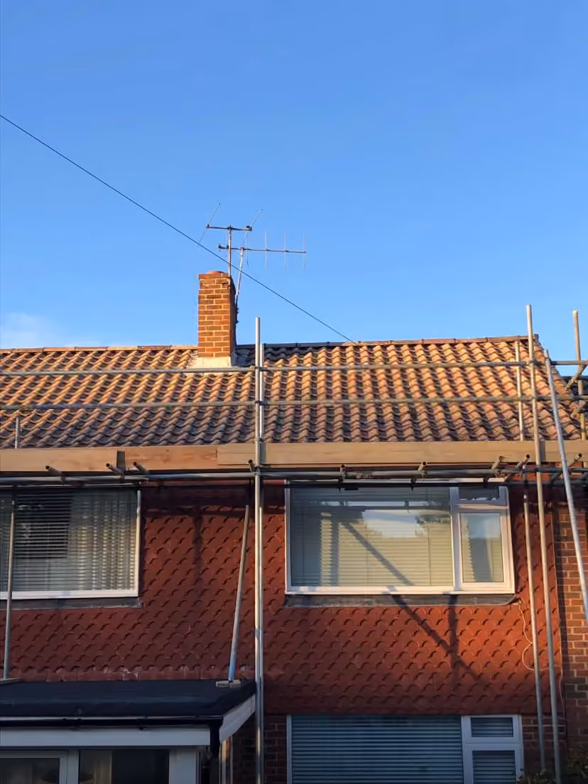 A semi mid reroof with new pantiles on one half and the old tiles on the other