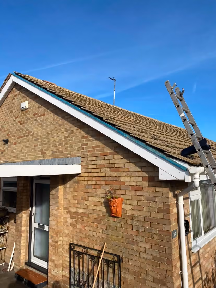 A bungalow with scaffold up the gable end