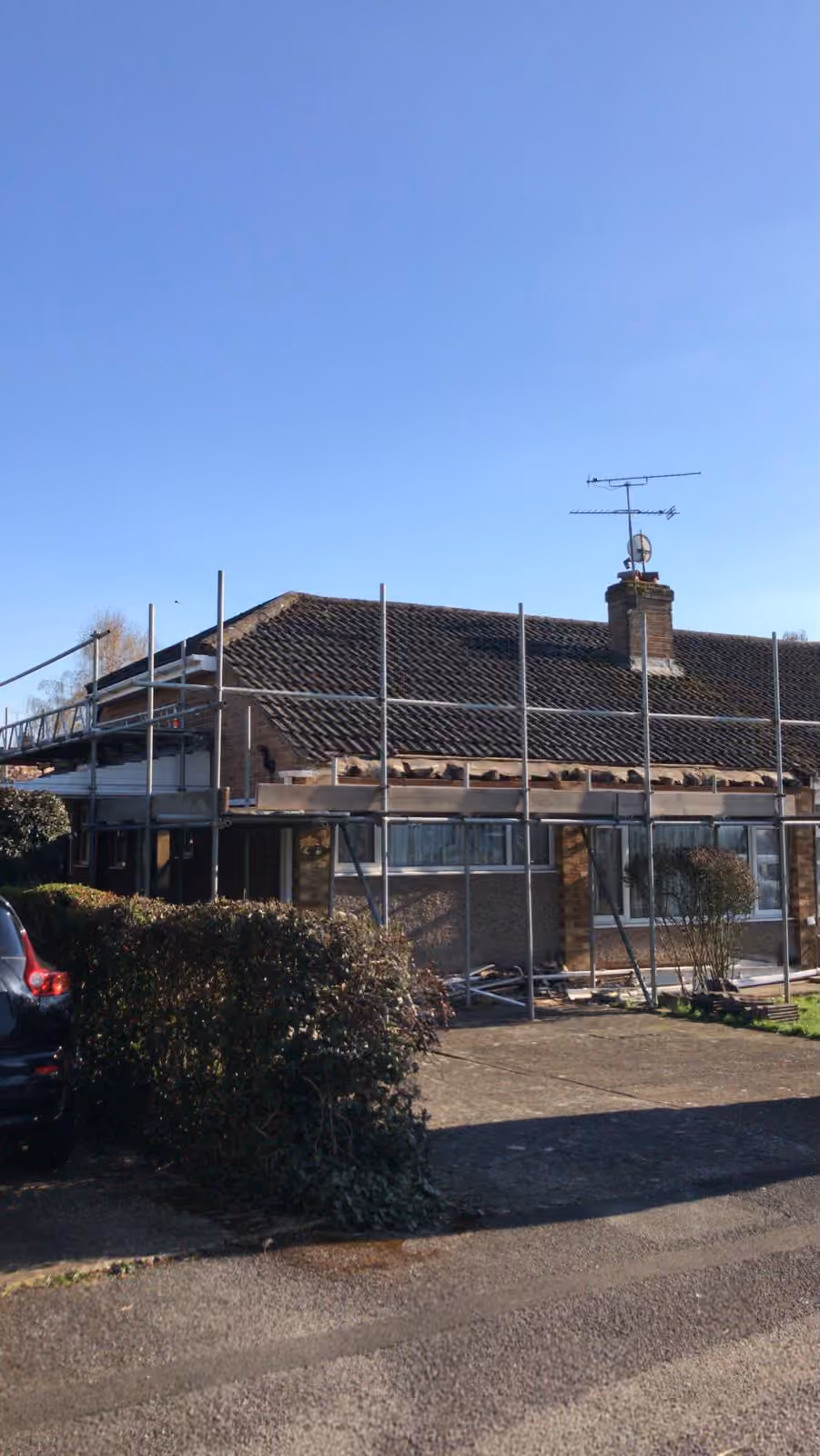 A bungalow with the eaves stripped back and new timber going in