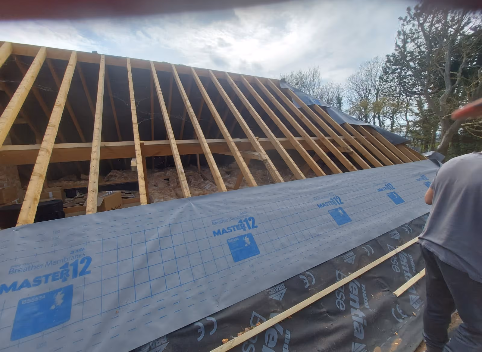 A roof stripped back to the timbers ready for reroofing