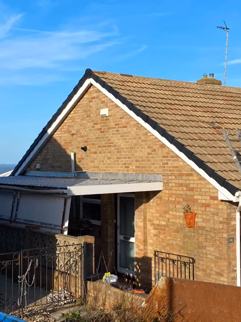 A bungalow with the roof opened up and scaffold in place