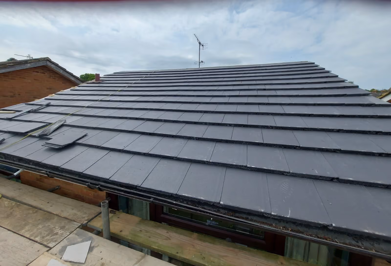 A finished dark covering laid out over a rear extension